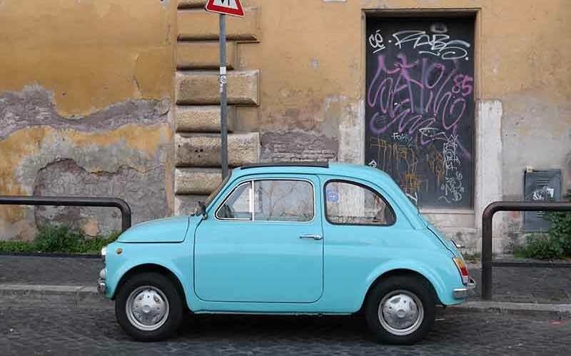 Liten blå bil parkert i Roma