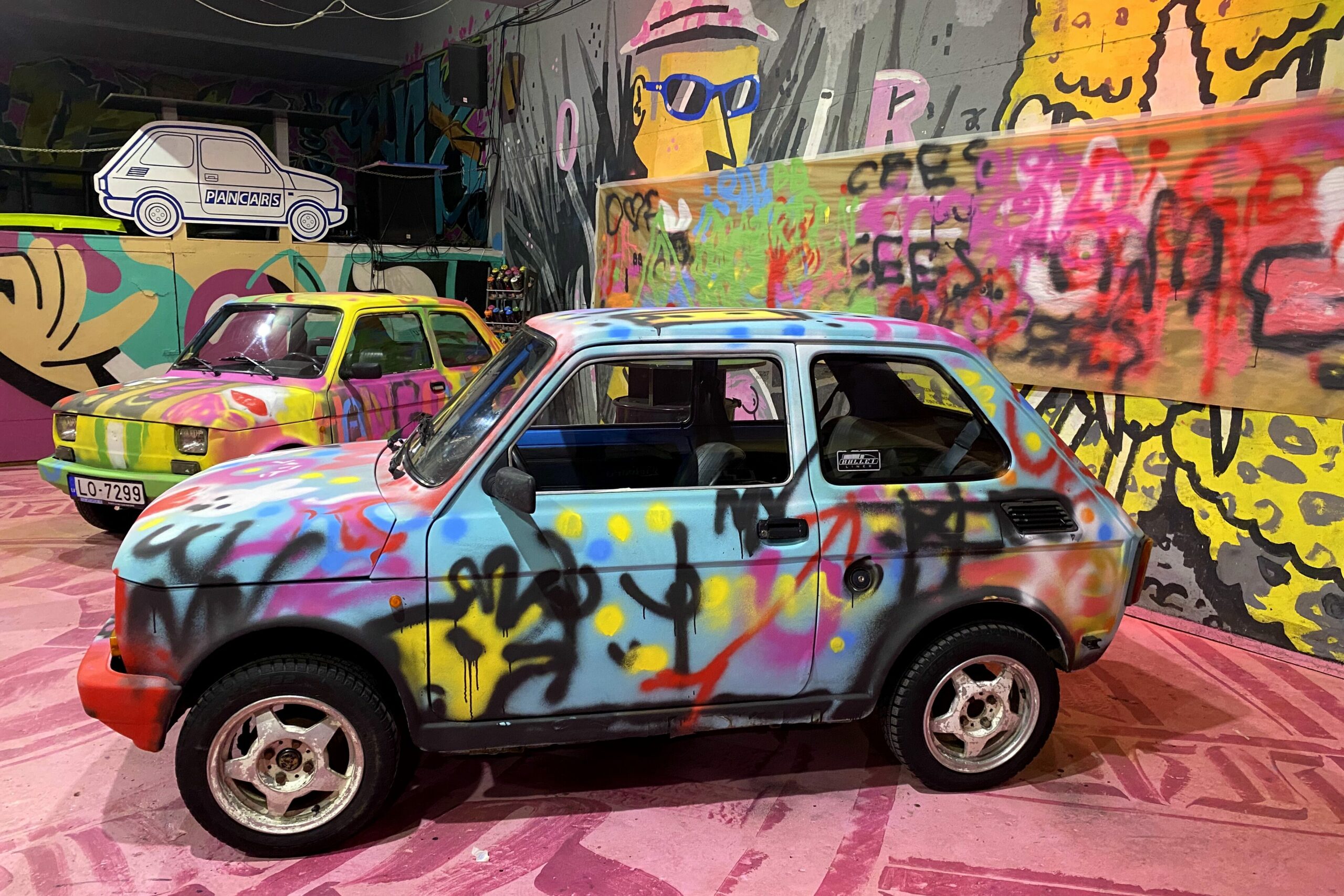 Fargerike Fiat-biler på utstilling. Foto